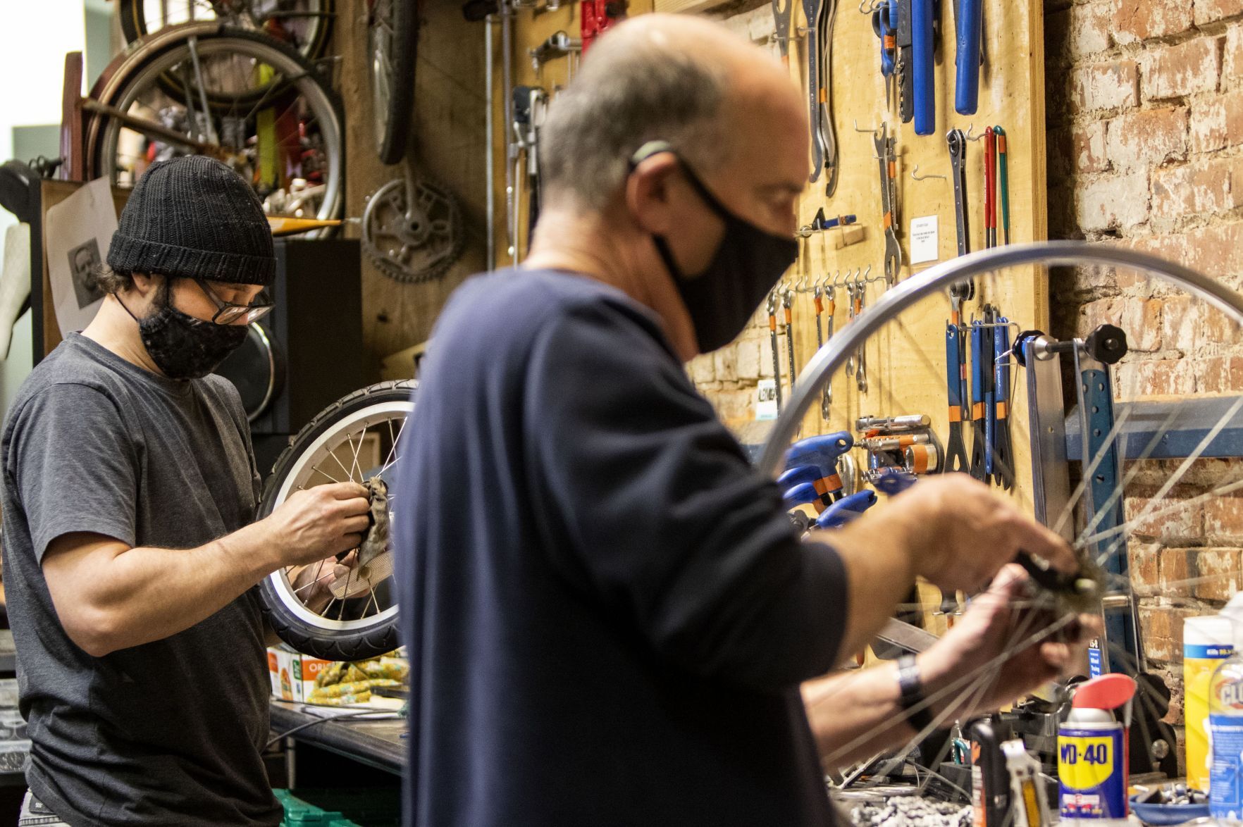 Volunteers and employees repair bikes at St. Louis BWorks in Soulard